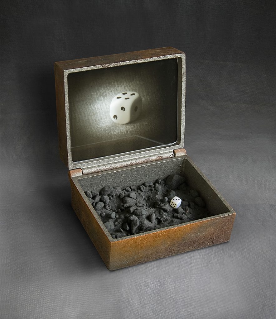 Dice. Cast iron, glass, black sand, wood, painting. 28 x 25 x 22 cm