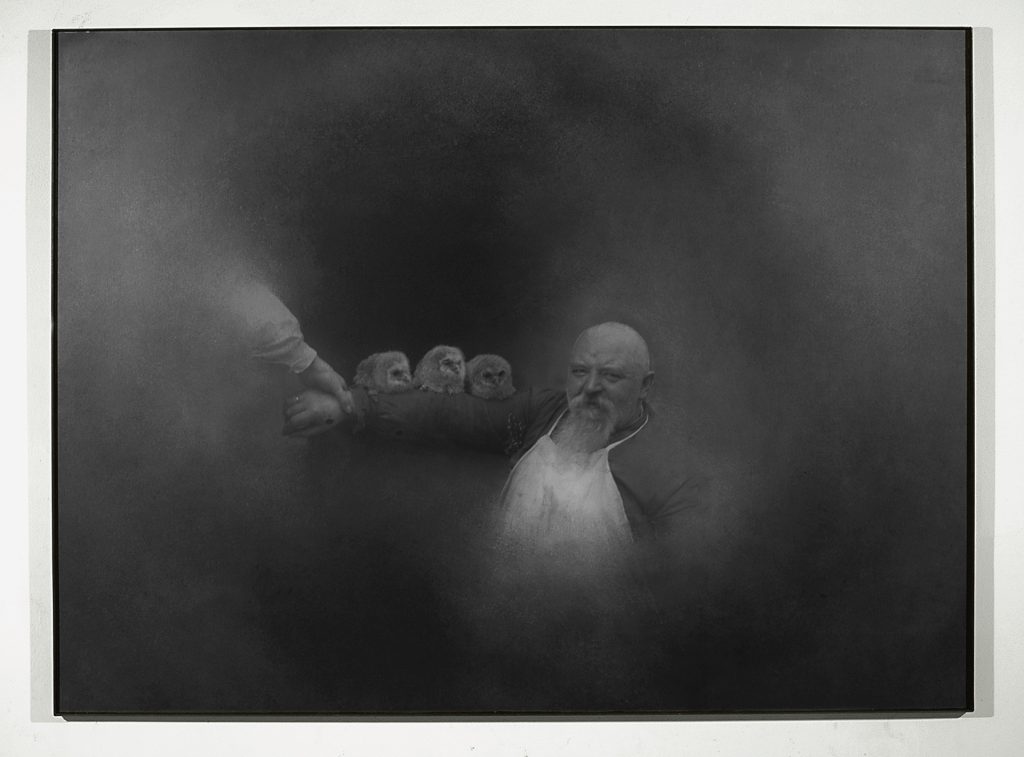 Untitled (Man with owls). Iron, macrodevelopment of photographic image. 125 x 170 x 4 cm