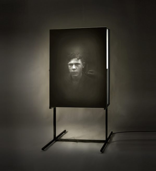 Untitled (boy). Emulsion on glass, light, iron.