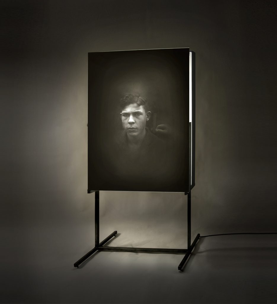Untitled (boy). Emulsion on glass, light, iron. 225 x 110 x 60 cm
