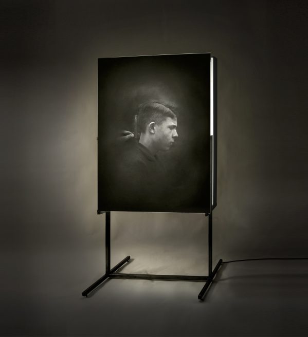 Untitled (boy), profile. Emulsion on glass, light, iron.